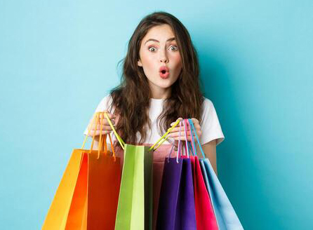 Amazed Young Woman Shopaholic Holding Colorful Shopping Bags And Look Amused At Next Shop Buying Things In Store Standing Over Blue Background Photo 1